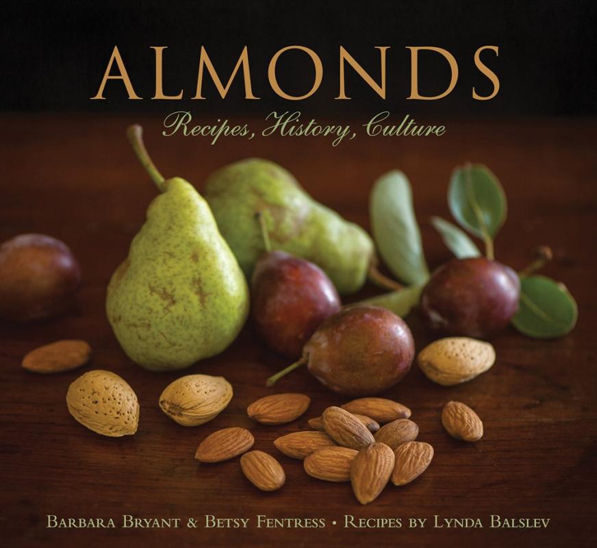 pile of almonds with green pears on wooden table with yellow text