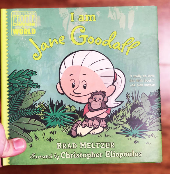 cute cartoon jane goodall hugs a chimp in the jungle