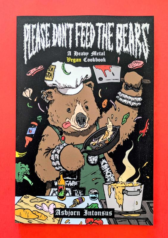 a punk rock bear with a chef hat cooks a meal.