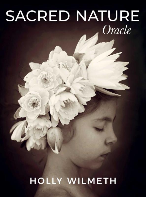 a black and white photograph of a girl wearing a flower crown