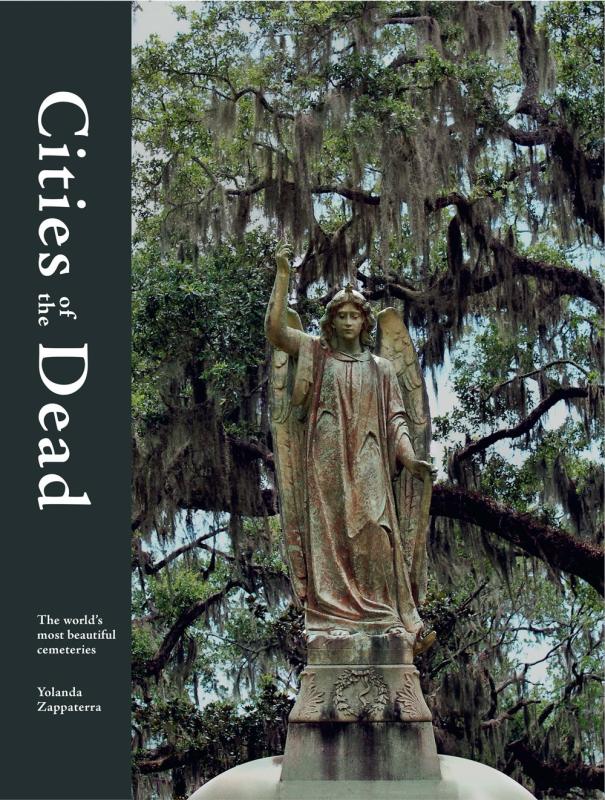 a photograph of a statue of an angel atop a mausoleum, with a moss covered tree in the background