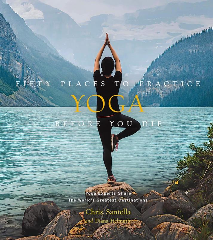 a person doing a yoga pose overlooking water and mountains