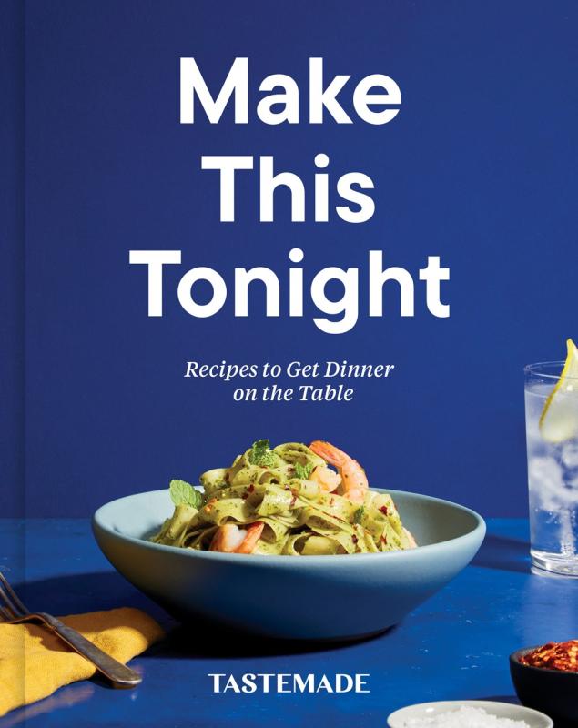 pasta bowl on a blue table and blue background, surrounded by miscellaneous dining tabled objects 