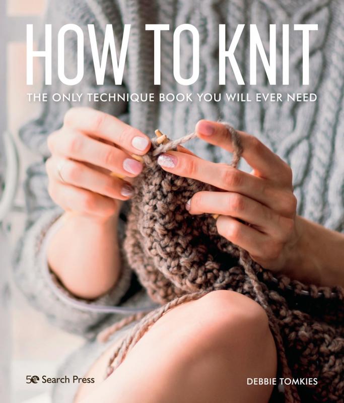 hands knitting a sweater while holding the rest of the fabric on a knee