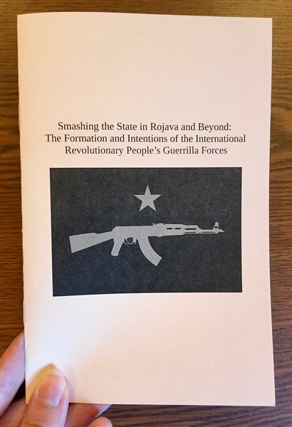 Cover of Smashing the State in Rojava and Beyond which features a star over a silhouette of a rifle.