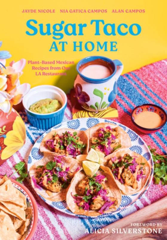 A brightly colored photo of tacos and other Mexican side dishes