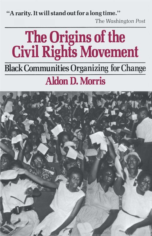 A B&W photo of black women holding up ballots.