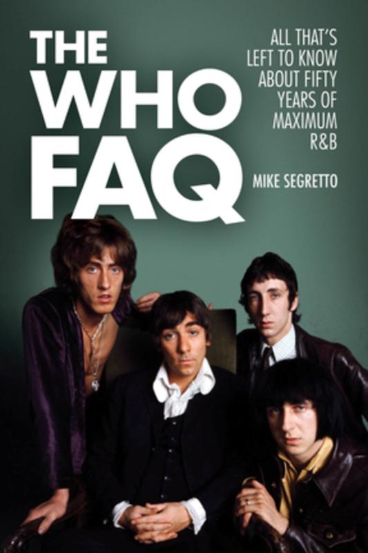 The four members of the who with a chalkboard behind them.