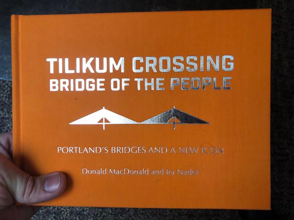 a gold-embossed bridge on an orange hardcover book